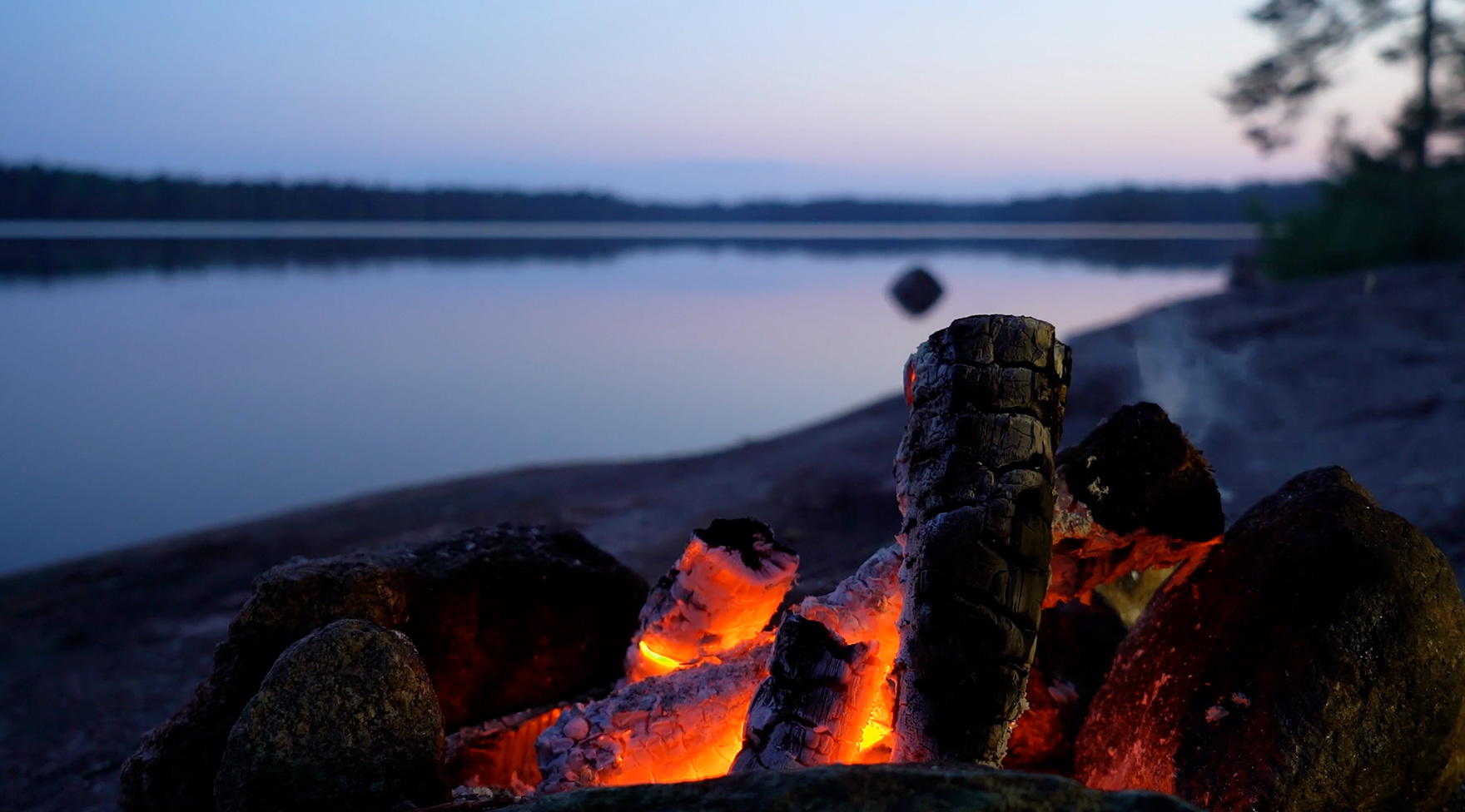 Thumbnail image of a campfire by the water in summer. Click to see Kerry and Mike Oliver’s testimonial video.