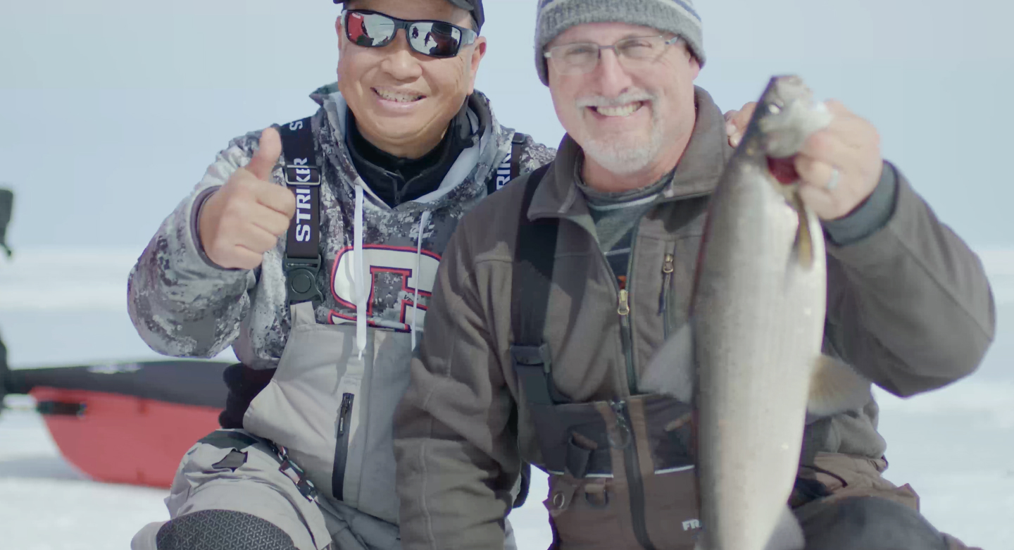 David Chong and Scott Morrow smiling after a catch on the water.