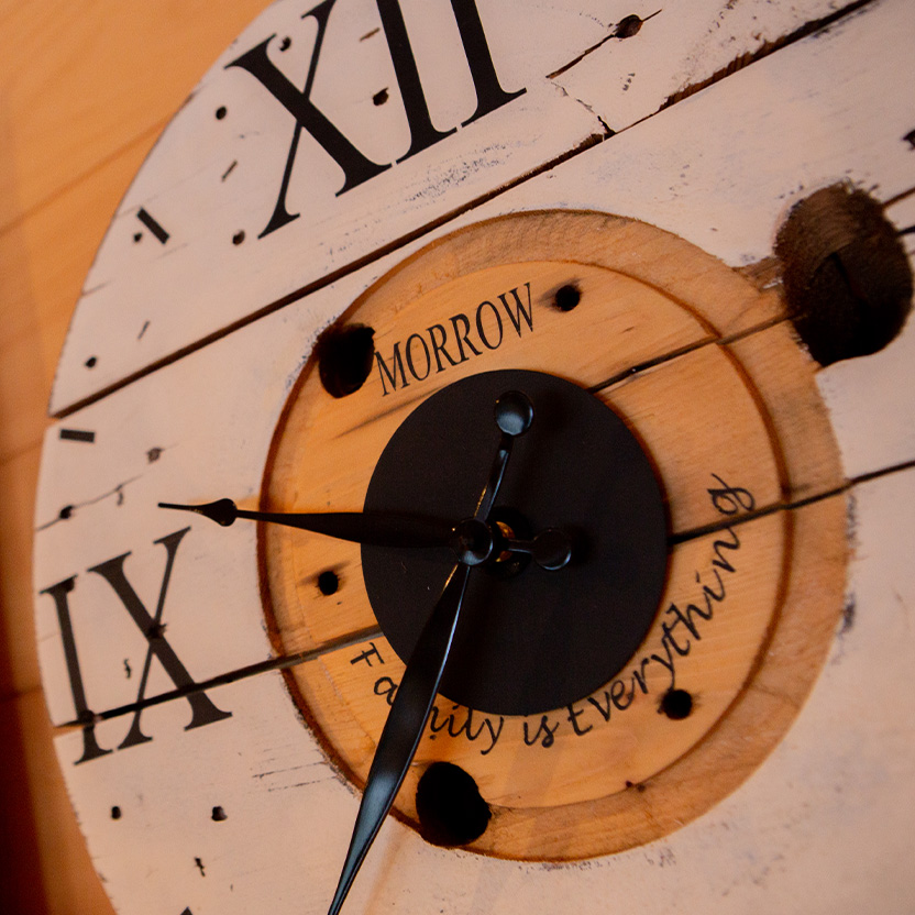 Close-up photo of a Morrow family clock with roman numerals and a personalized inscription that reads ‘family is everything’.