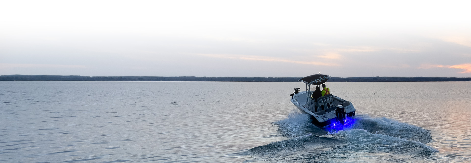 Panoramic shot of Scott Morrow out on the water with his boat in summer.